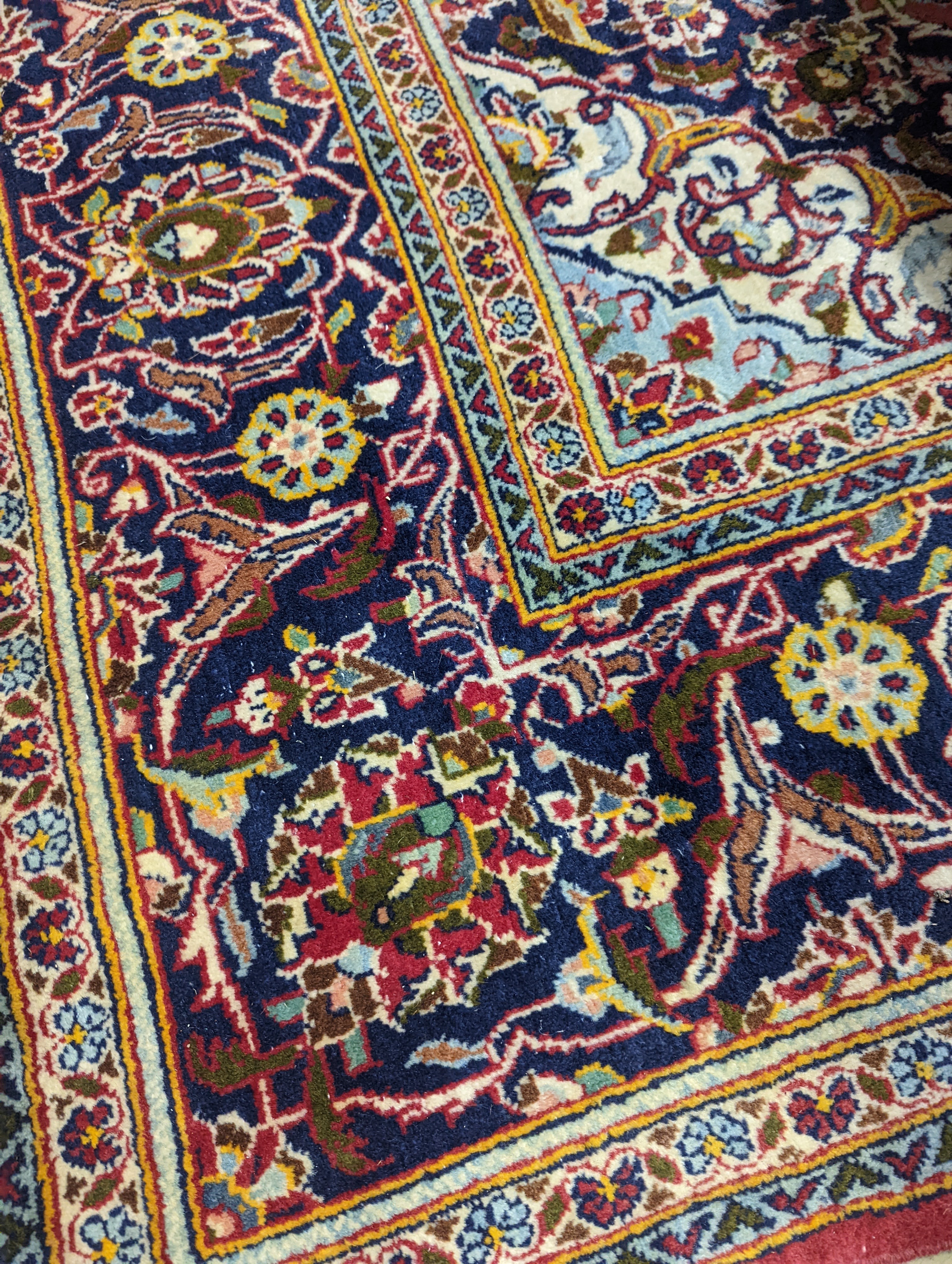 A Heriz red ground carpet, 320 x 204cm